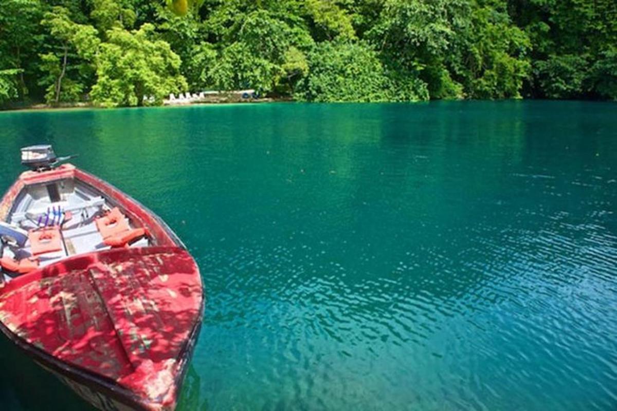 una barca rossa seduta in mezzo a un lago