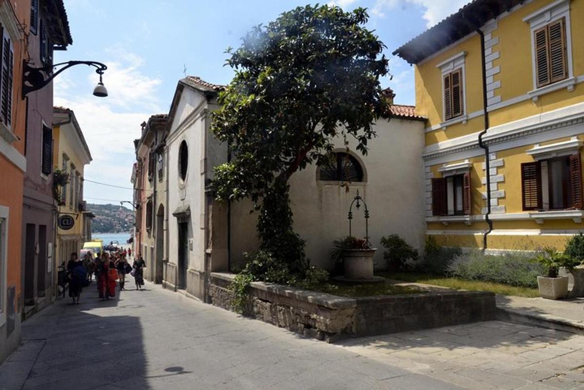 a group of people walking down a street with buildings