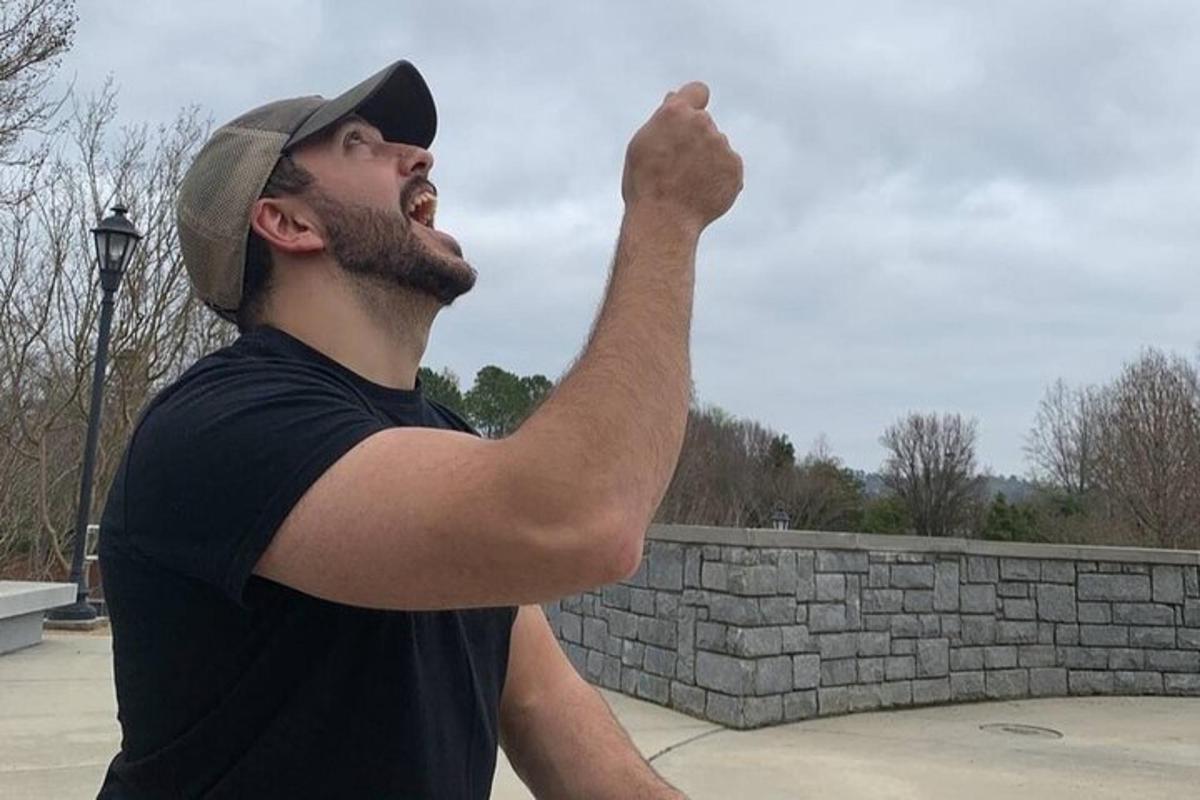 a man holding his fist up in the air