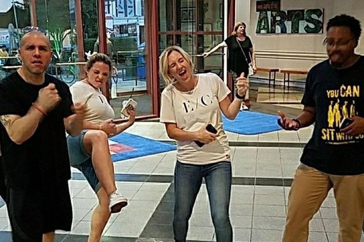 a group of people dancing in a mall
