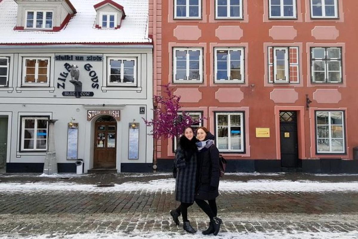 two women standing in front of a building