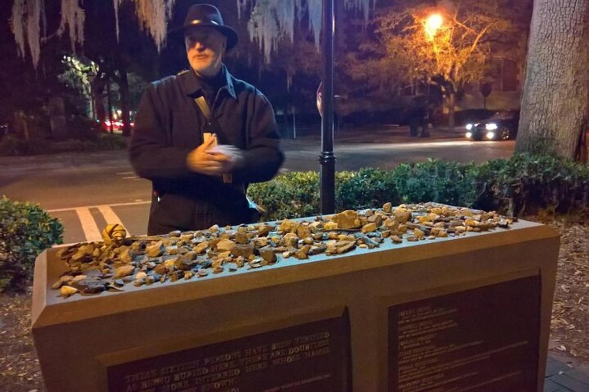 a man standing next to a pile of pigeons