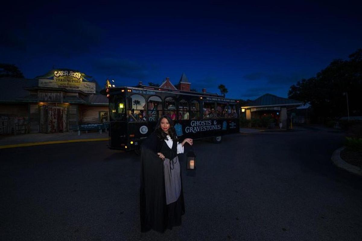 a woman is standing in front of a bus