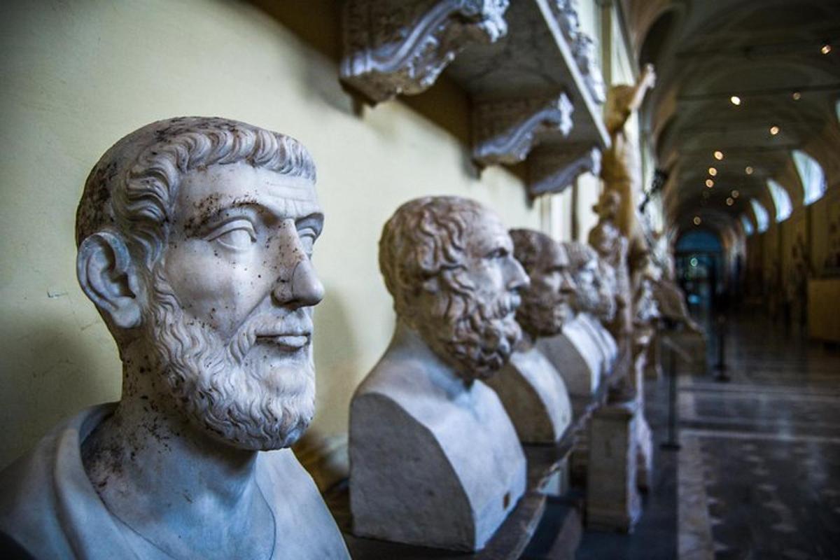 a group of statues of men in a museum