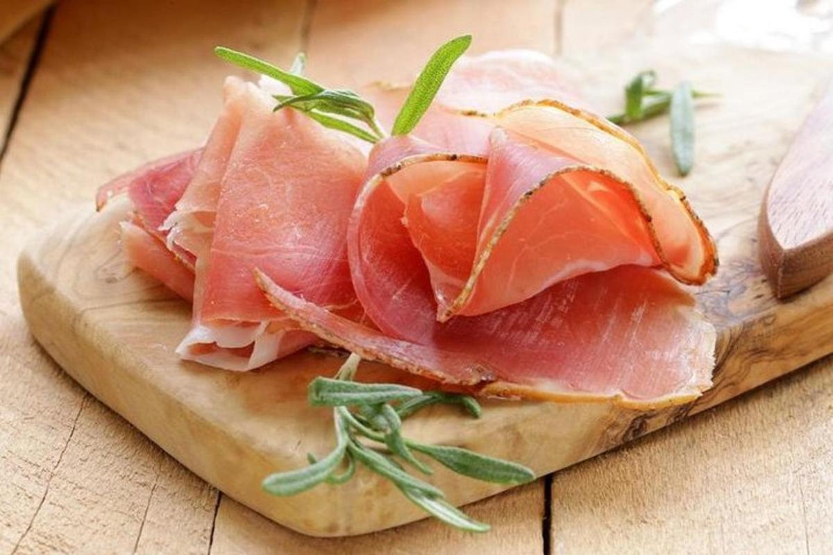 a pile of ham on a cutting board on a table