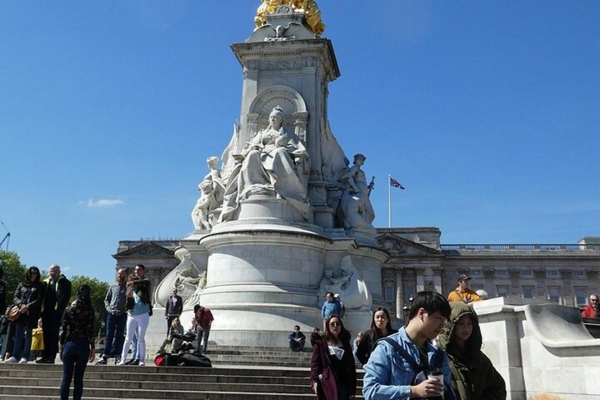 a group of people standing in front of a statue