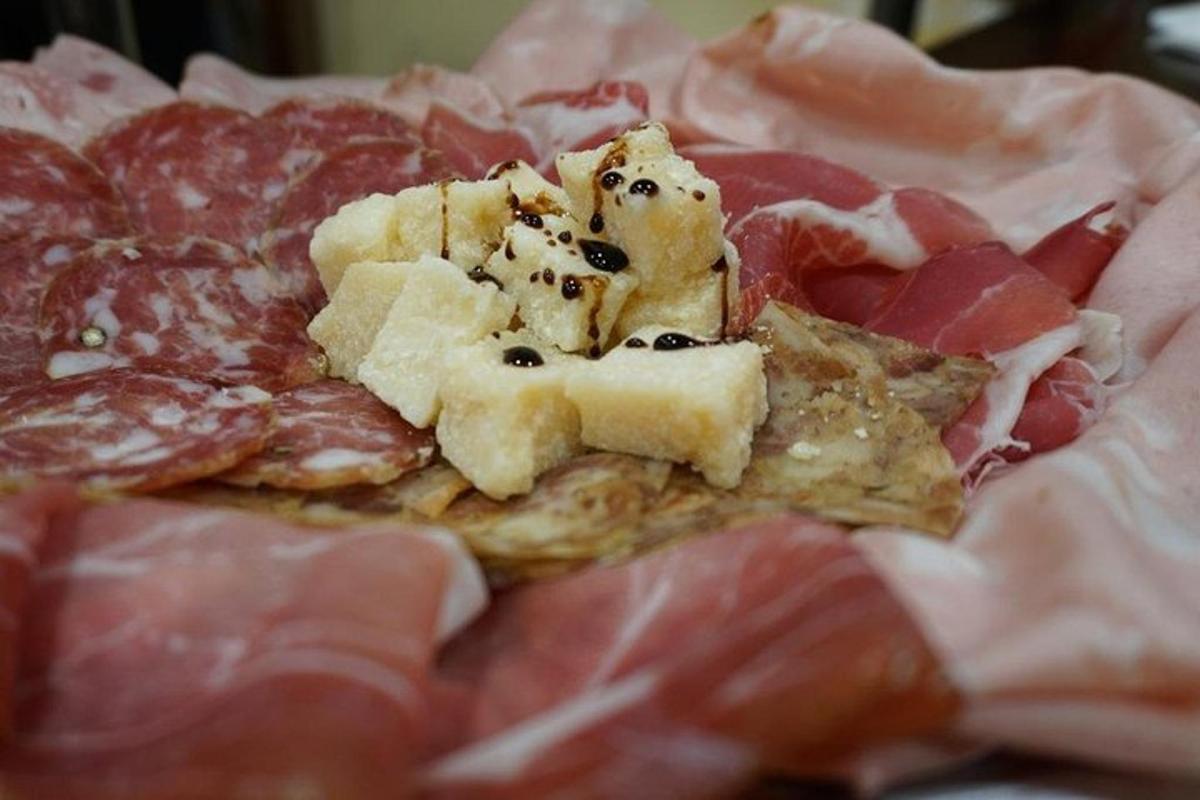 a plate of food with meats and cheese on it