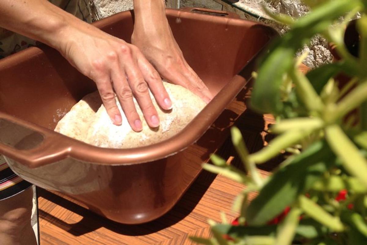 a person is kneading the dough in a pan