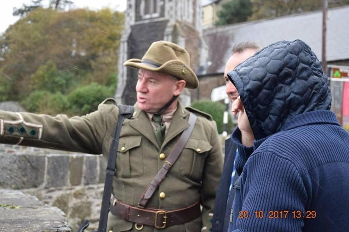 a man in a military uniform pointing at a woman