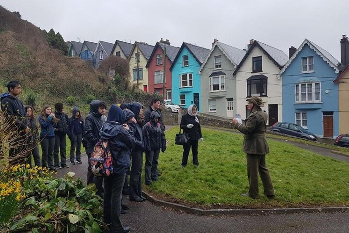a group of people standing in front of a row of houses