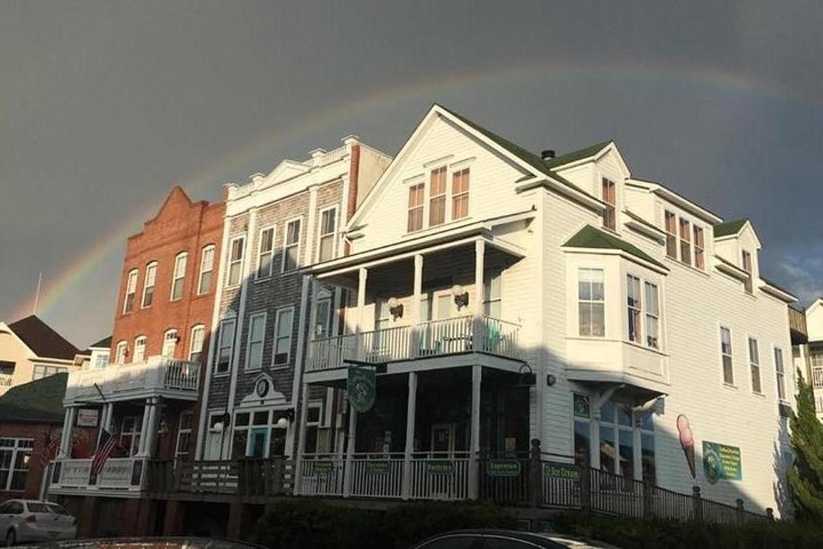 a group of houses with a rainbow in the sky
