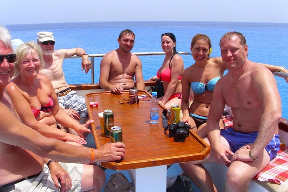 a group of people sitting around a table on a boat