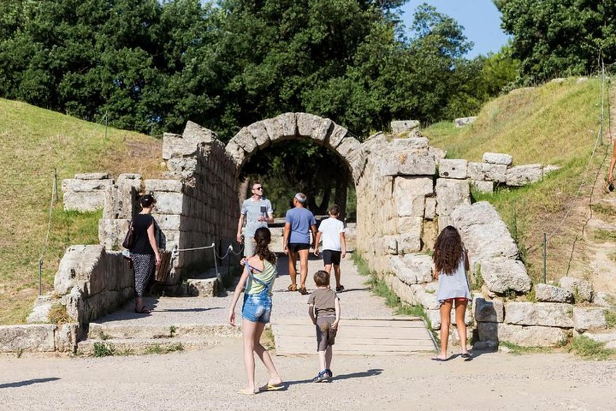 a group of people walking through a stone tunnel