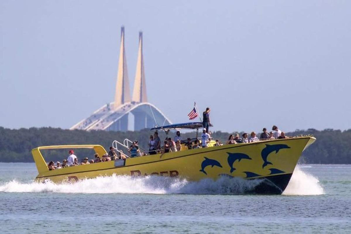 a yellow boat in the water with people on it