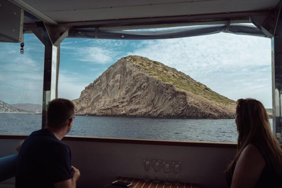 a man and woman sitting on a boat looking out the window