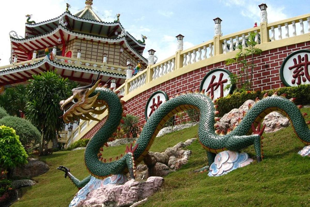two green dragon statues in front of a building