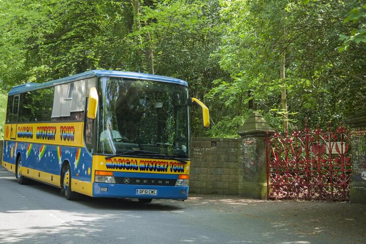 a blue and yellow bus driving down a street