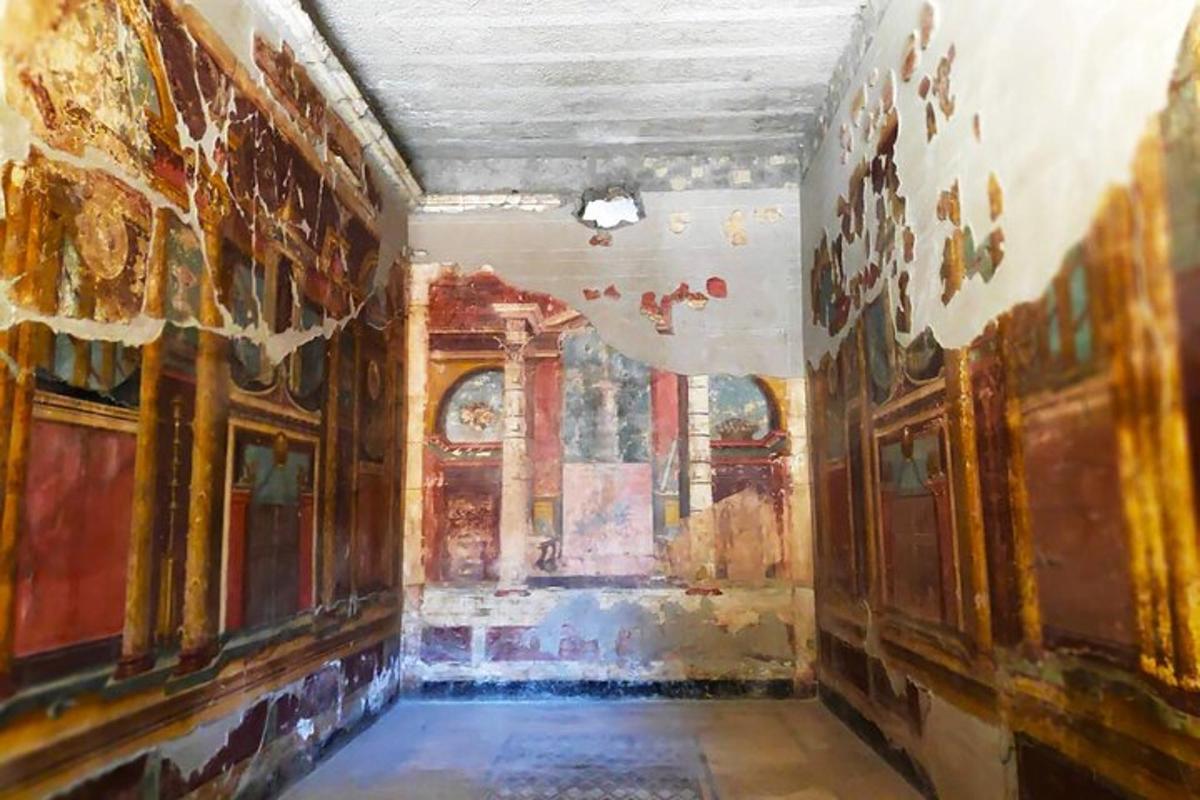 a room with paintings on the walls of a building