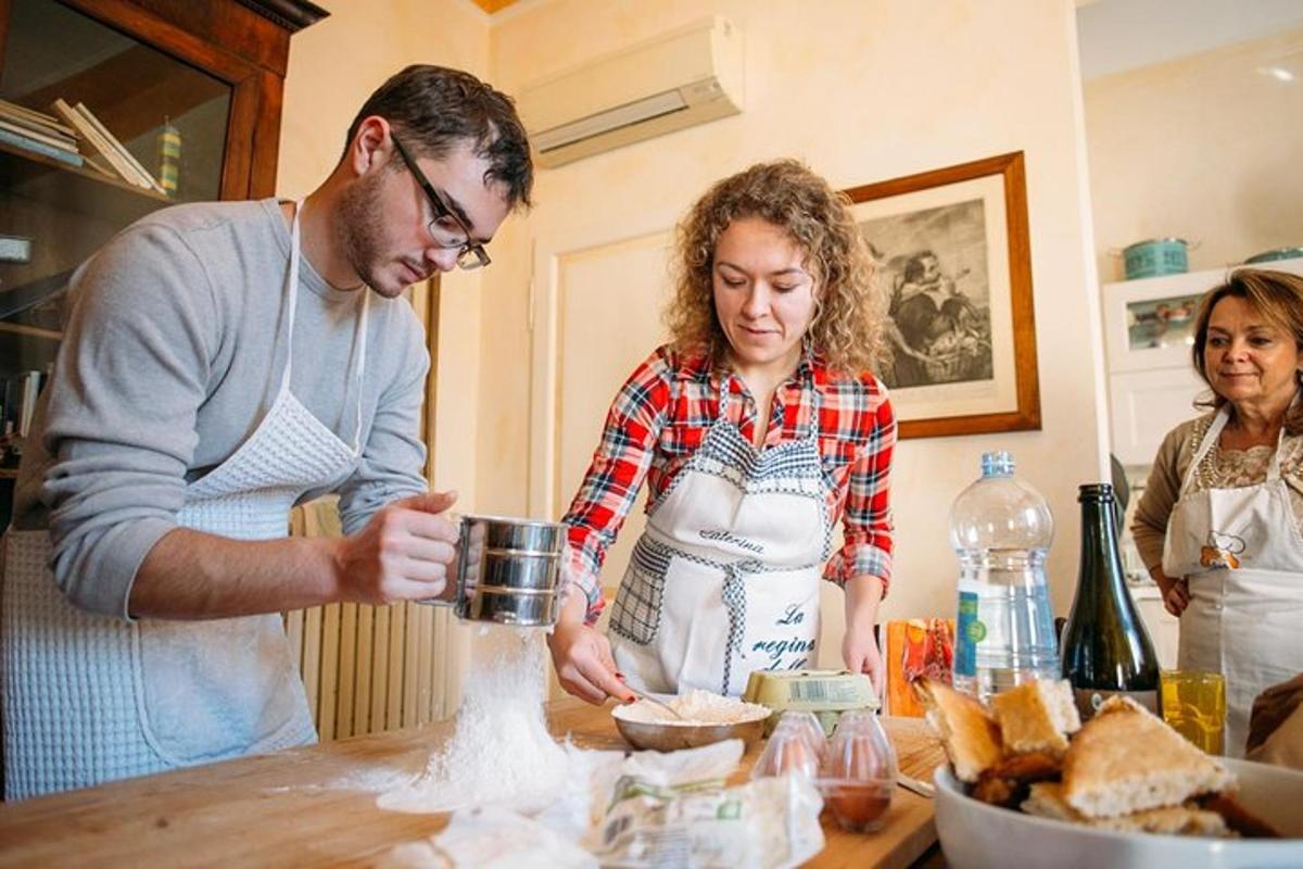 a man and woman standing in a kitchen preparing food