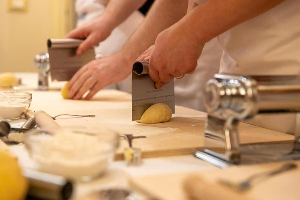 a person cutting a piece of food on a cutting board