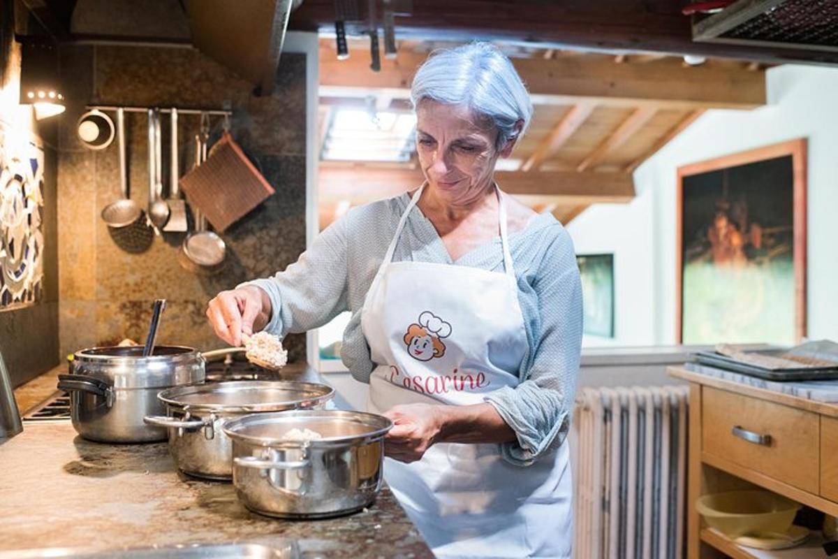 a woman in a kitchen preparing food in pots