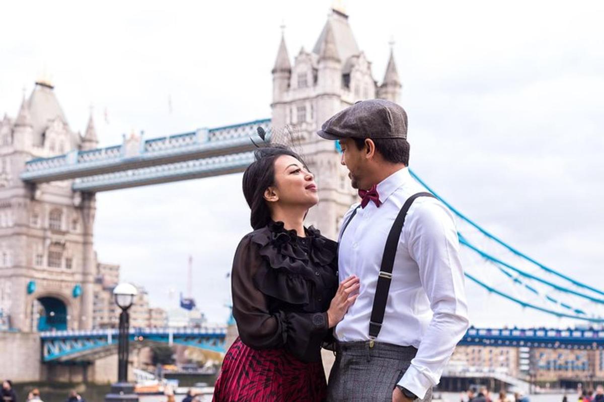 a man and a woman standing in front of a bridge