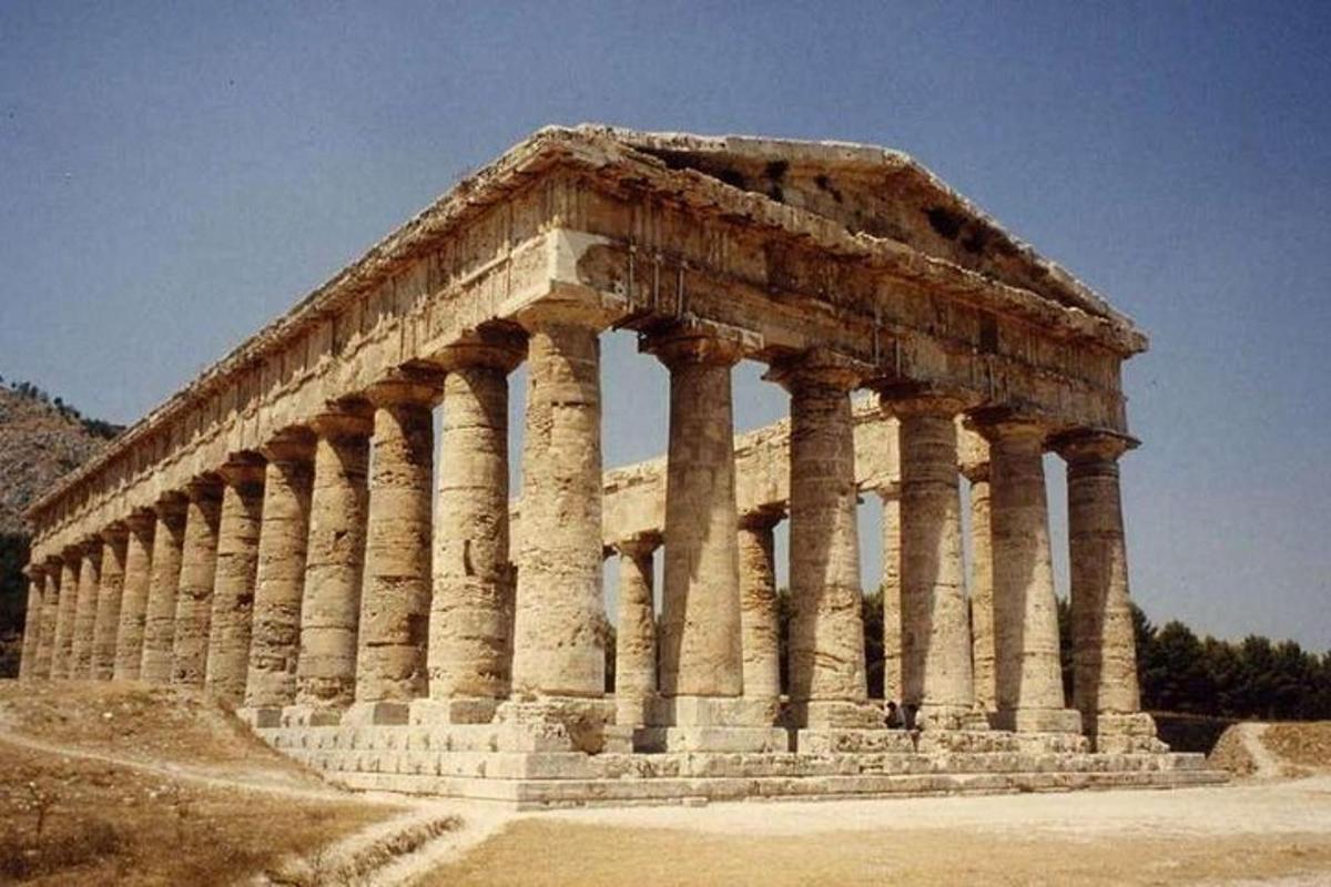Un edificio antiguo con columnas en una colina.