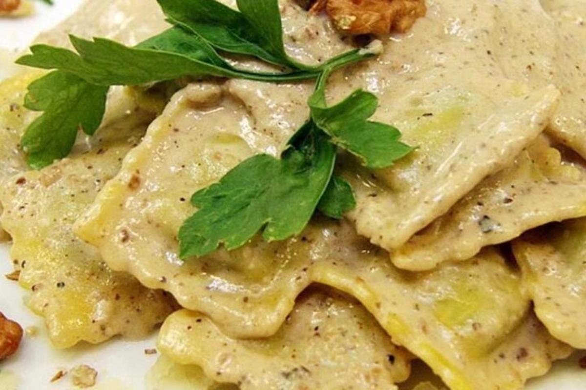 a plate of pasta with parsley on top of it