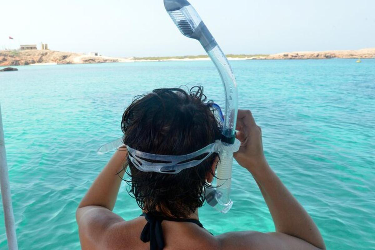a woman in the water with a mask on