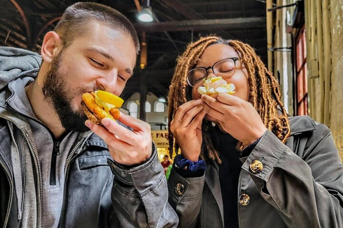 a man and a woman eating hot dogs