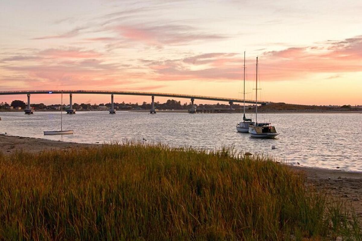 a boat in the water with a bridge in the background