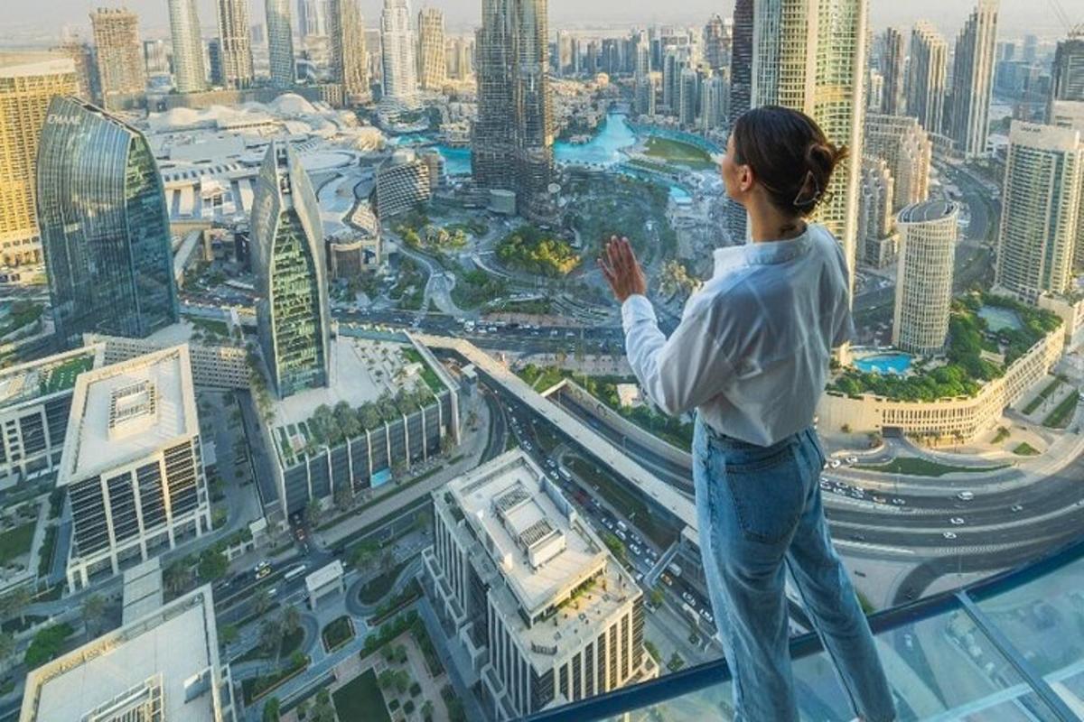 a woman standing on top of a building