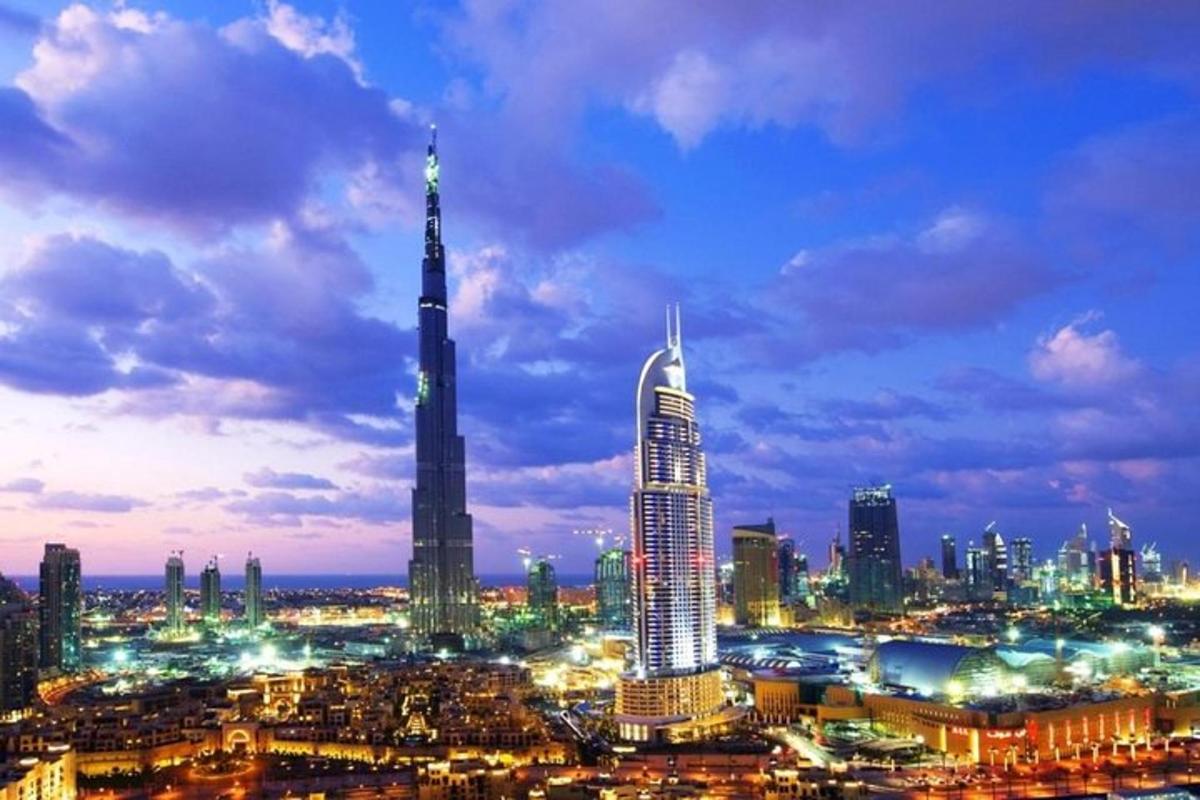 a city skyline at night with a tall building