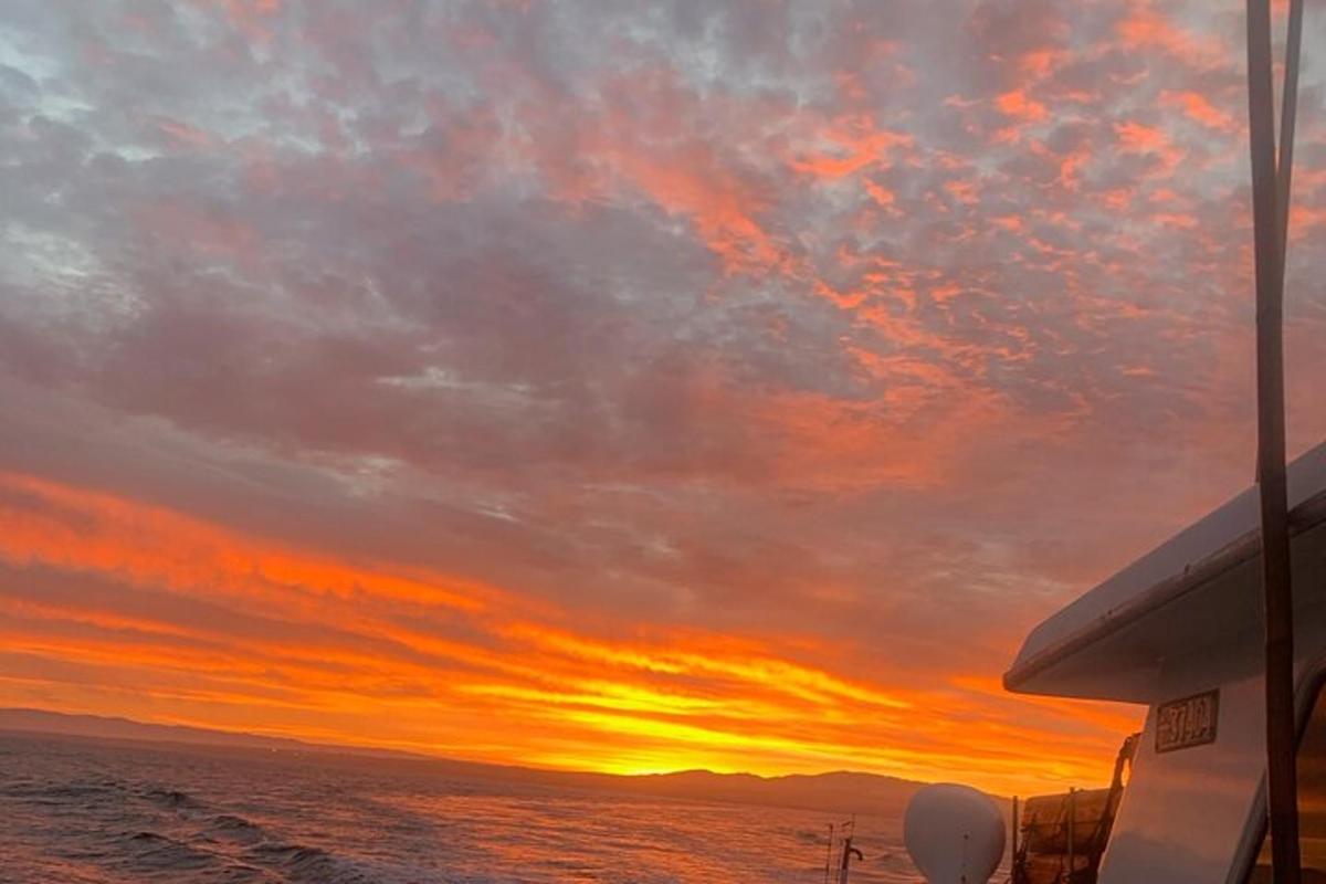 a sunset on a boat in the ocean