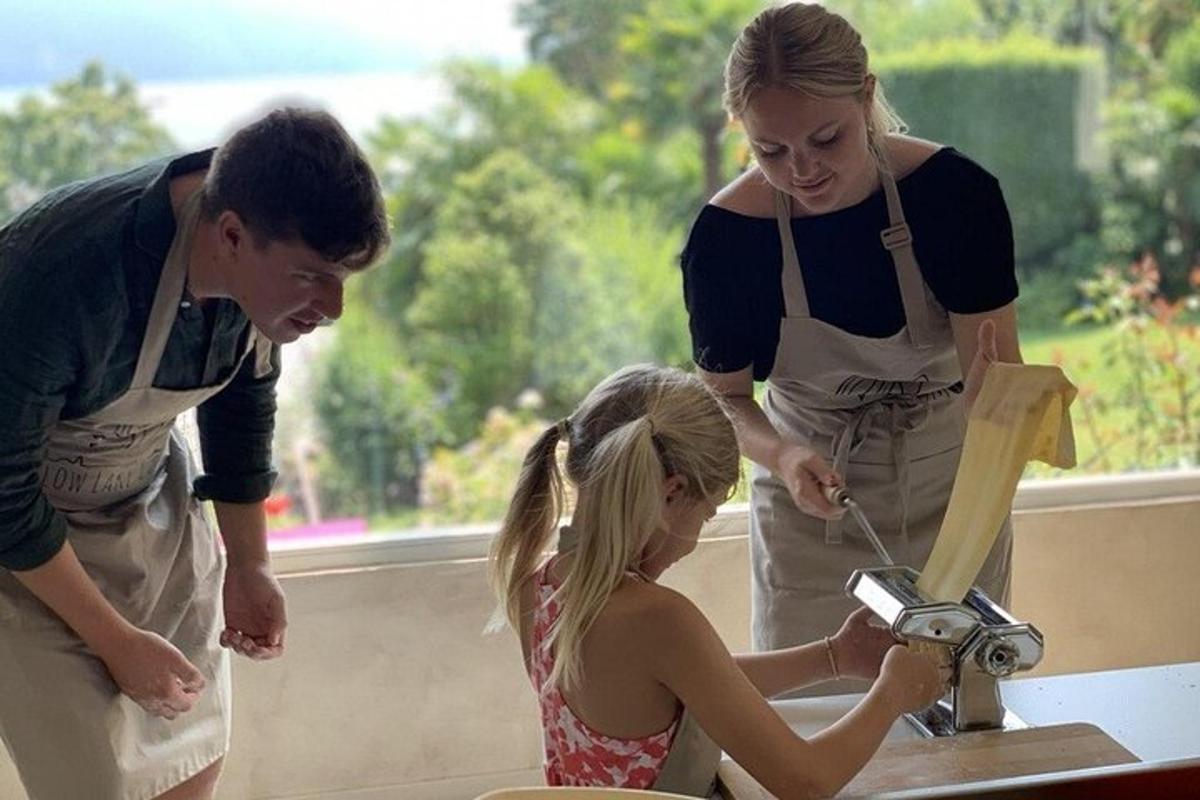 a group of people standing around a girl using a machine