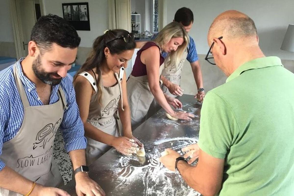 a group of people standing around a table preparing food