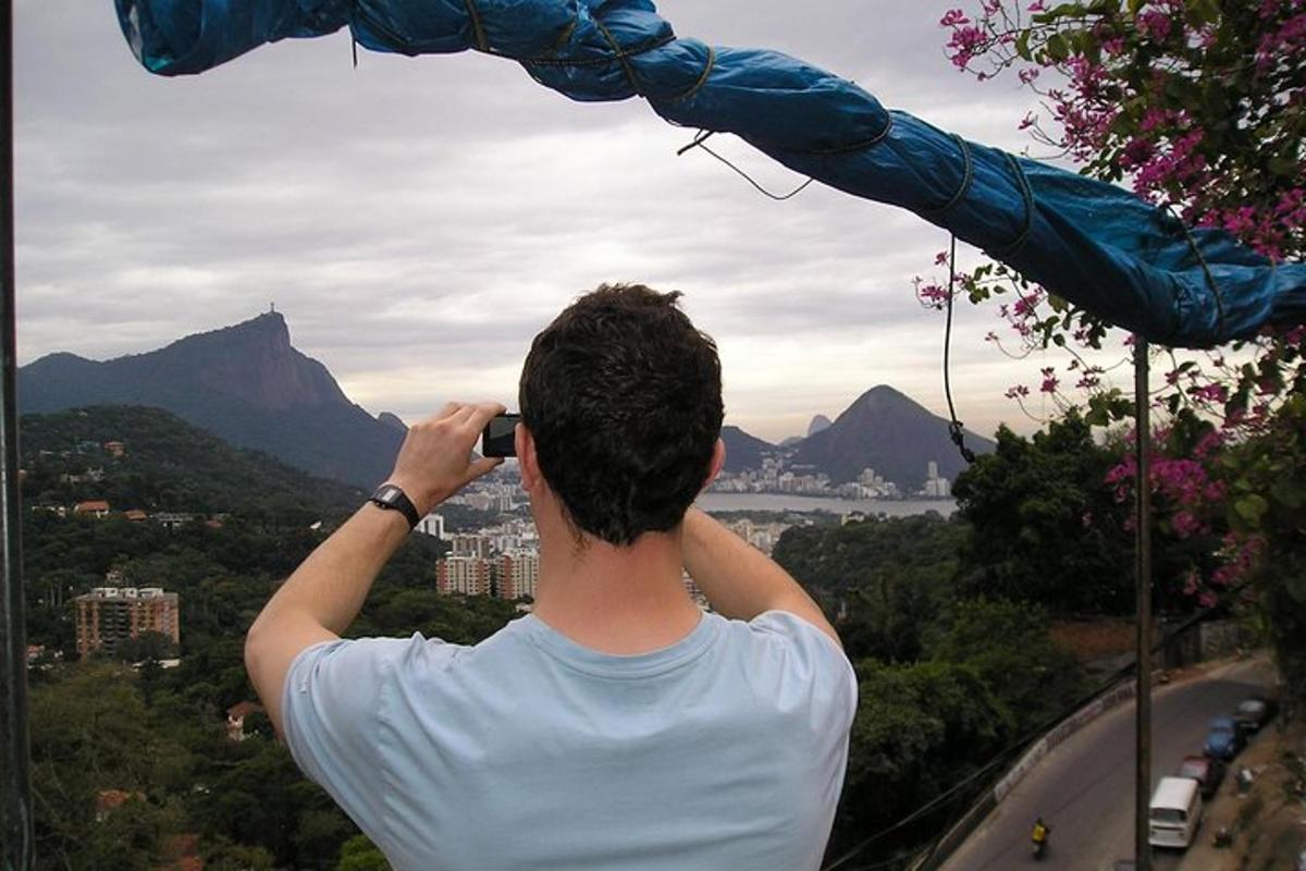a man taking a picture of a city with his cell phone