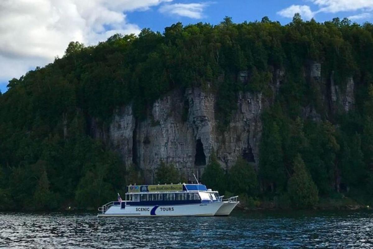 a boat on the water in front of a mountain