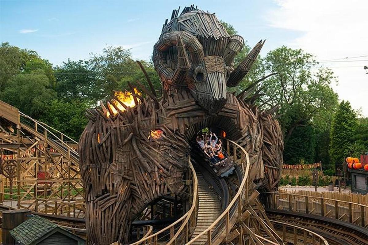 a theme park with a roller coaster in a theme park