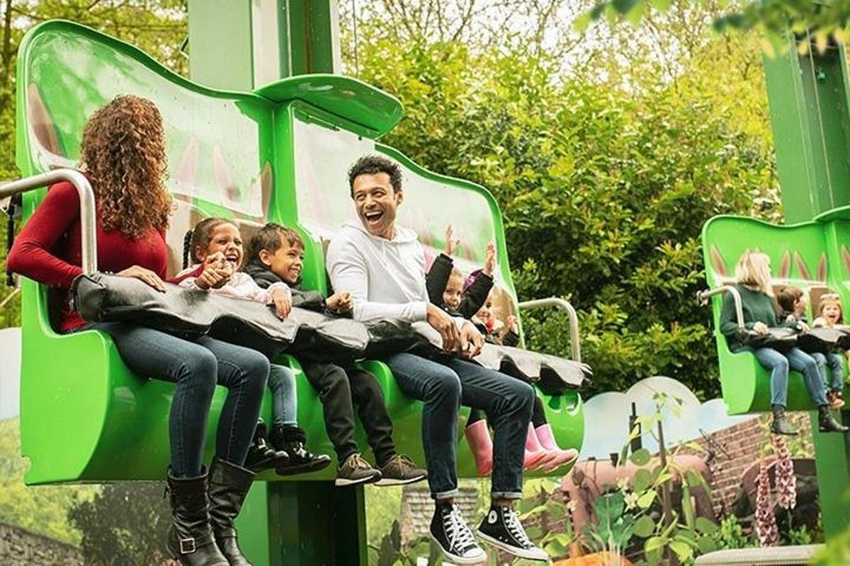 a family sitting on a ride on a roller coaster