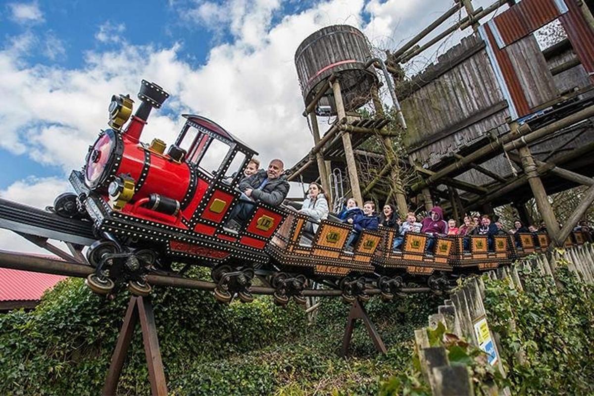 a group of people riding on a toy train