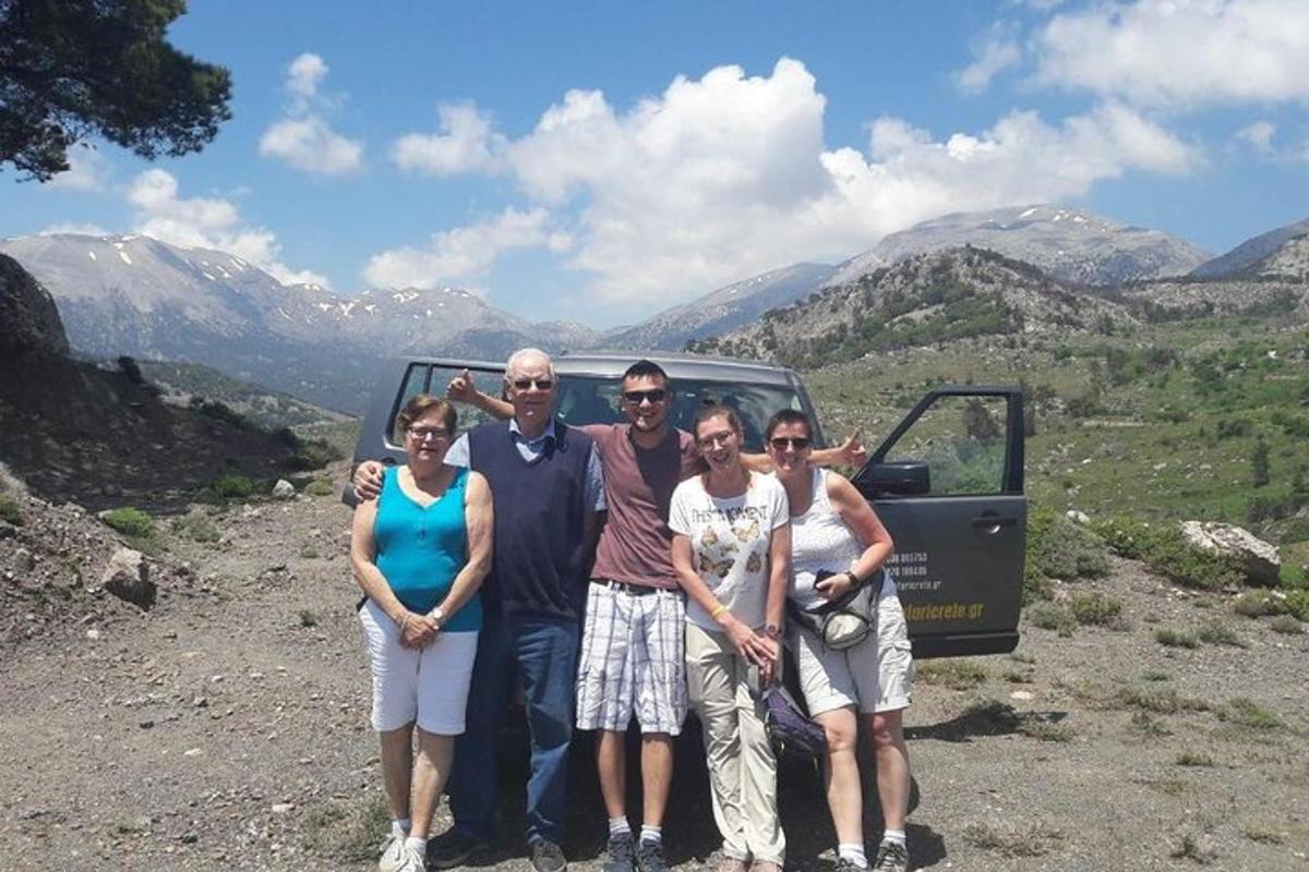 a group of people posing for a picture on a mountain