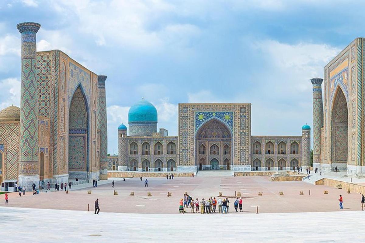 a large building with people standing in front of it