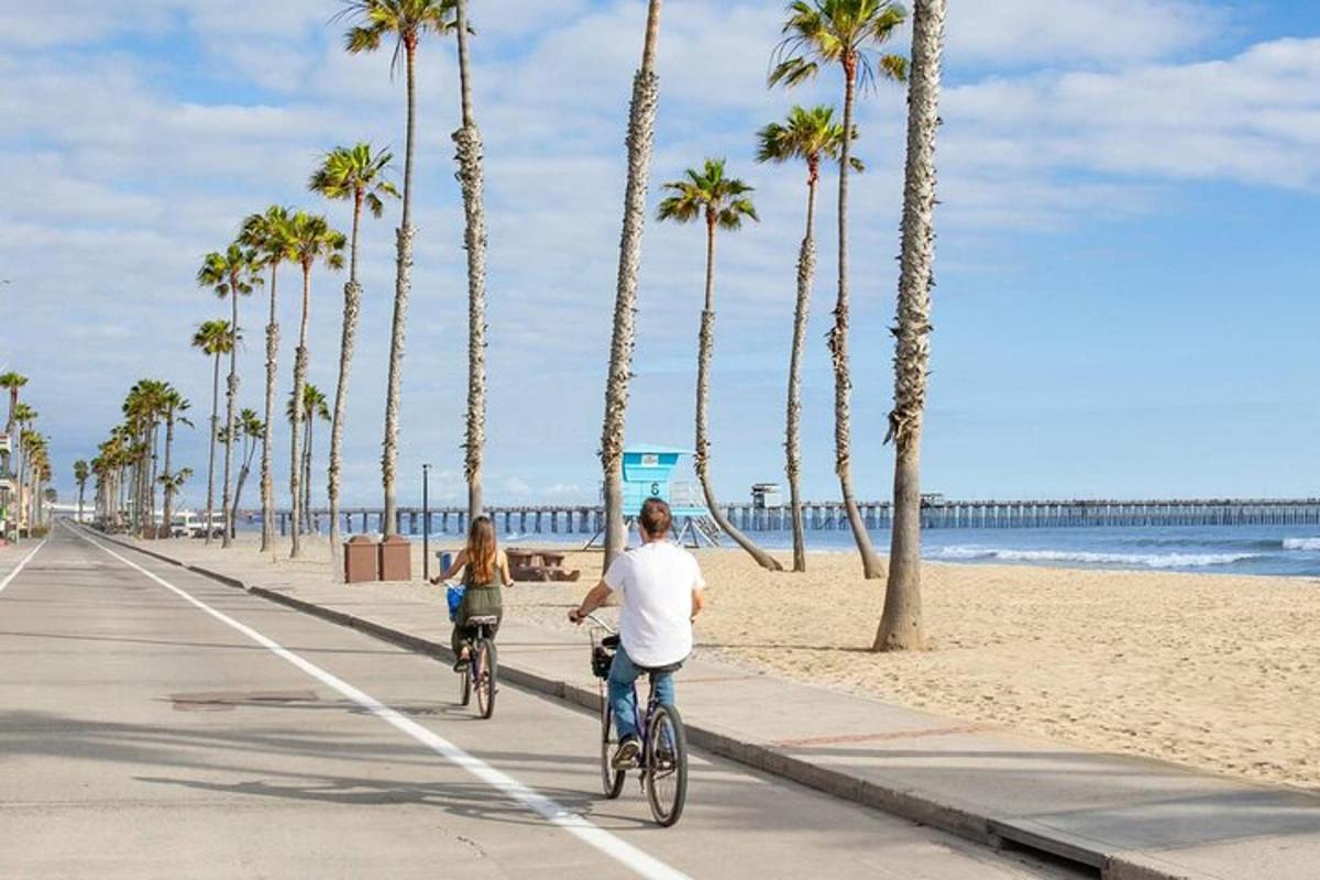 a man and a woman riding bikes on the beach