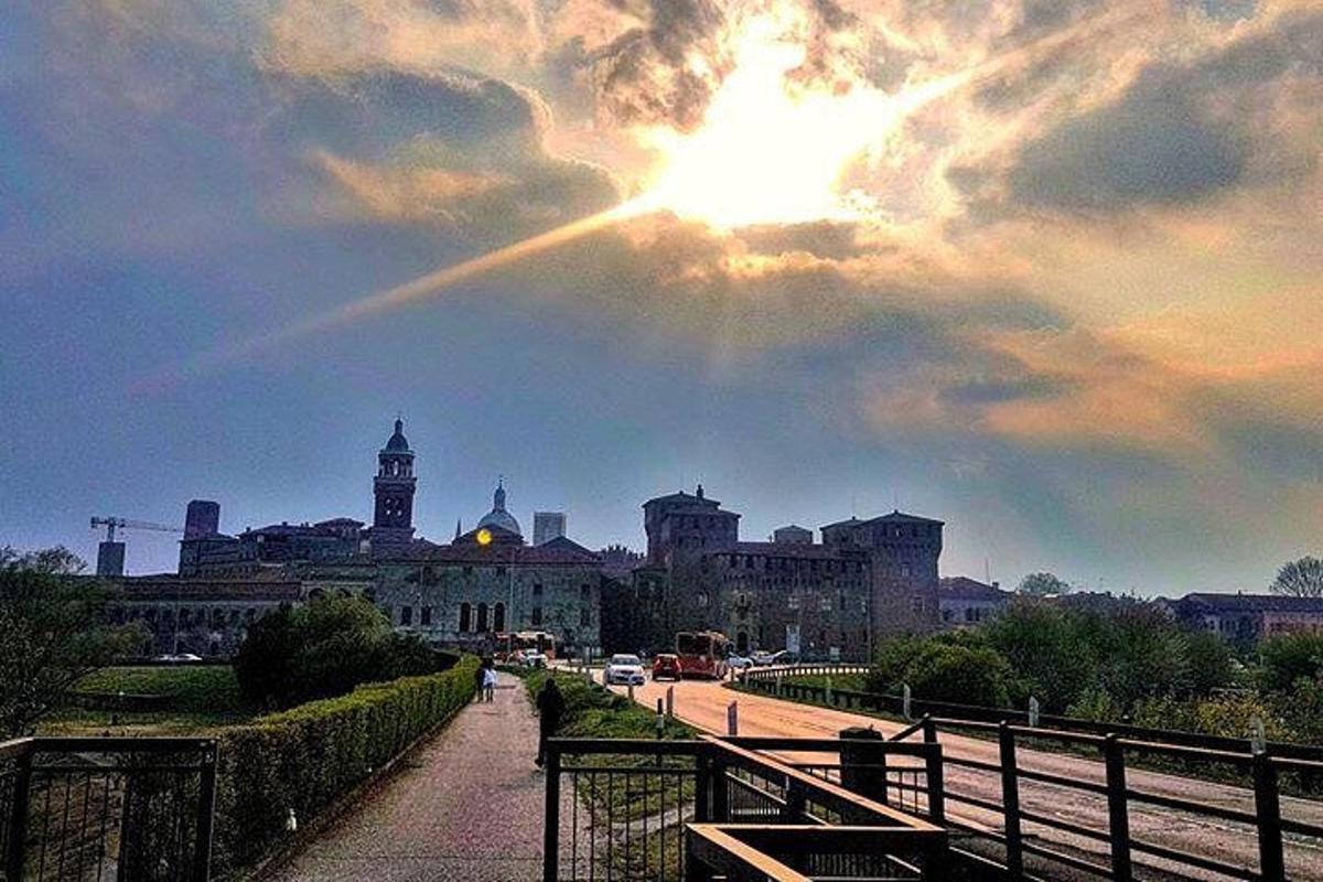 a view of a city with the sun in the sky