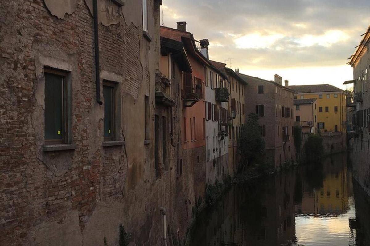 an alley with buildings next to a river