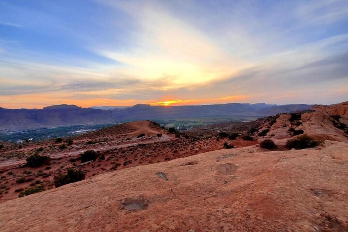 a view of the sunset from the top of a mountain