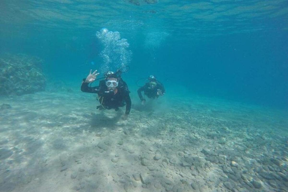 two people are standing in the water in the ocean