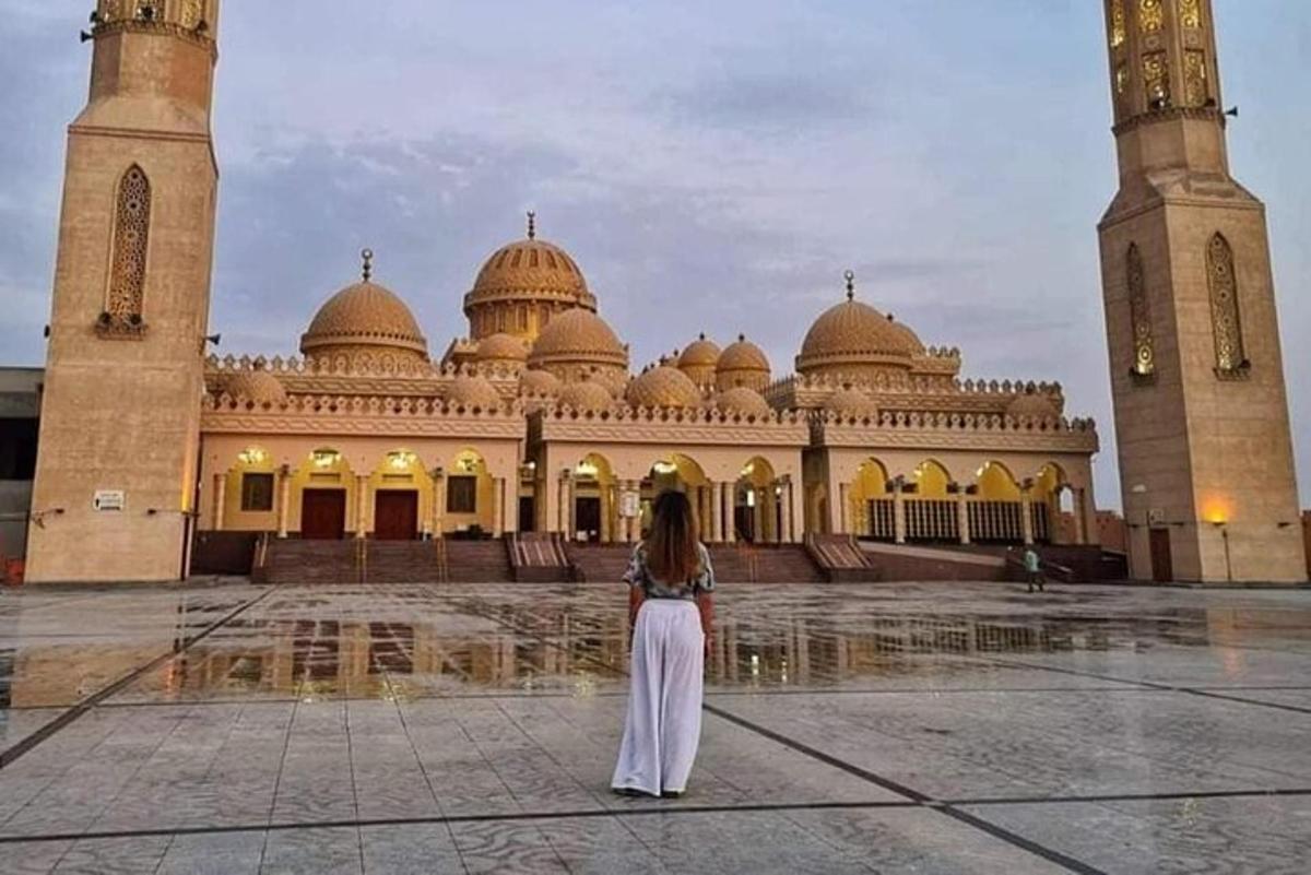 a woman standing in front of a large building