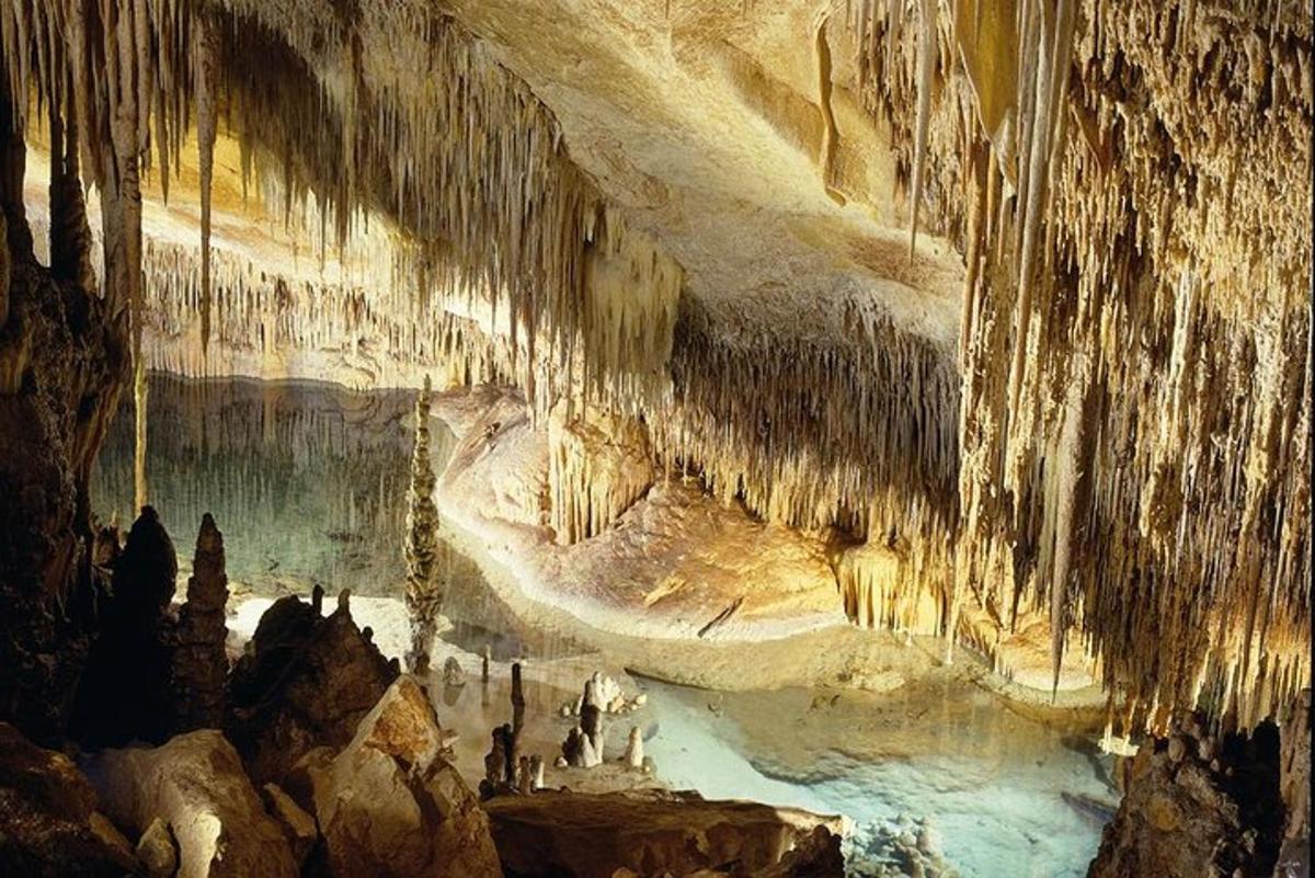 a painting of a cave with people in it